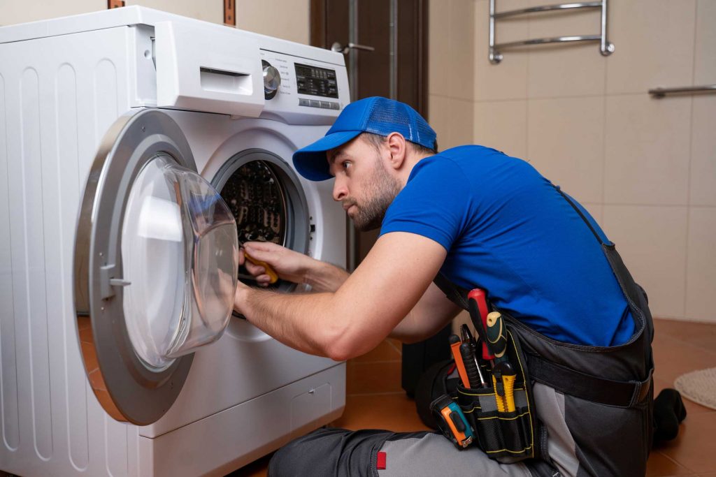 a technician repairing a washer and dryer repair trenton